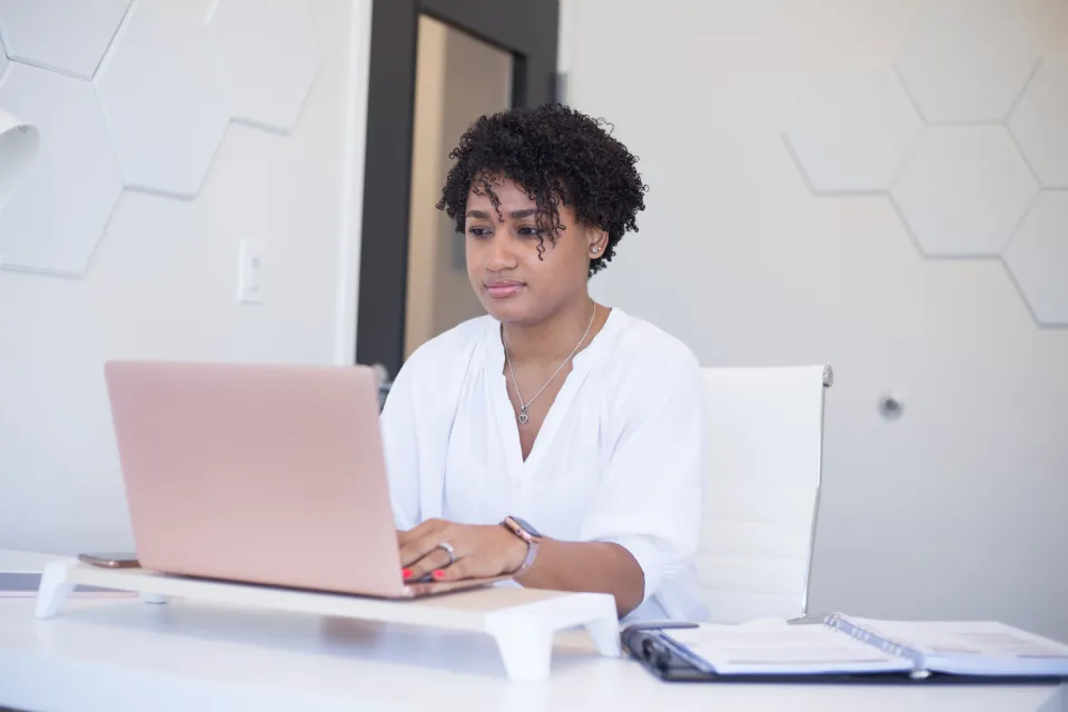 A young woman working on her laptop at home