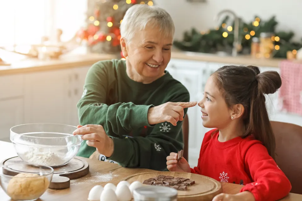 A grandmother baking with her granddaughter